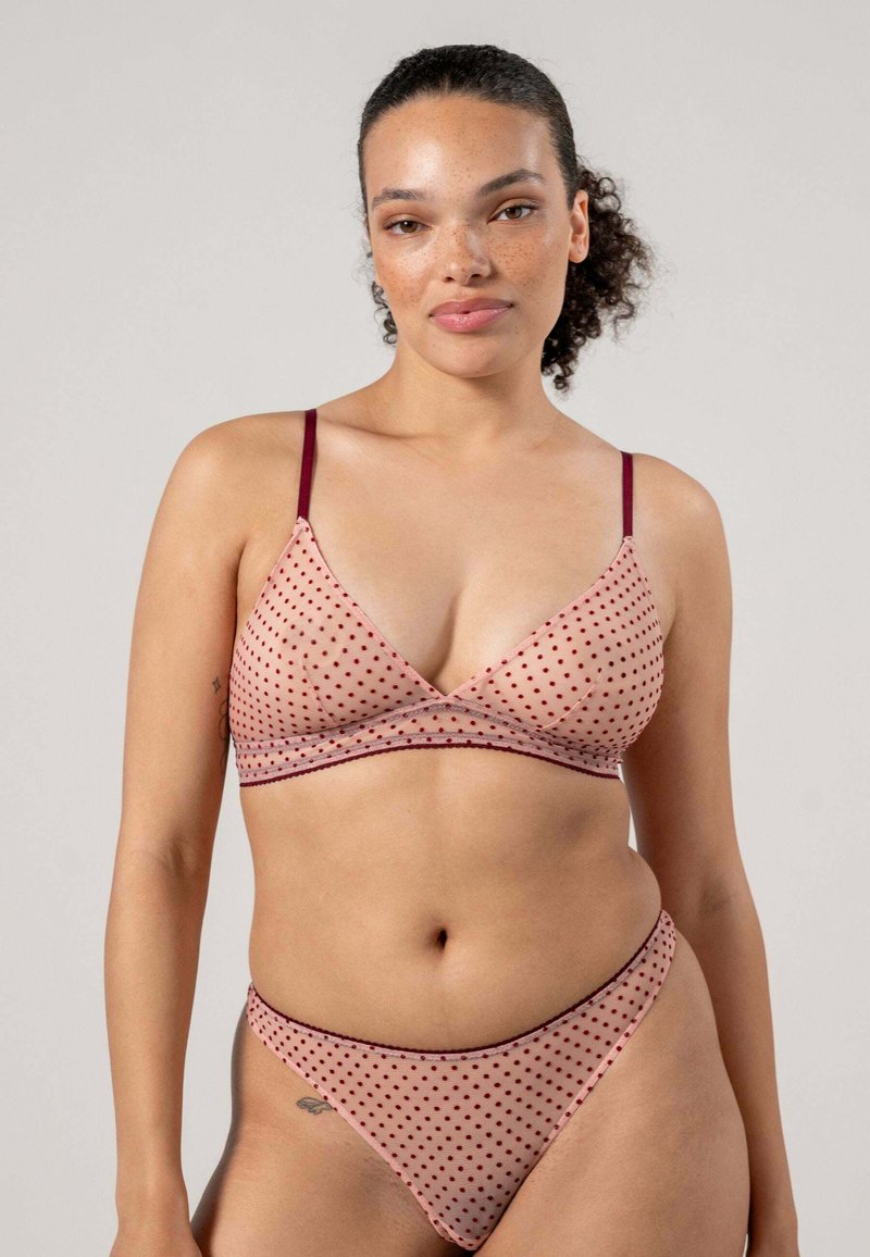 Rosa prickig bralette och matchande trosa, med tunna vinröda remmar, genomskinlig struktur och triangulär design. Höga benöppningar.