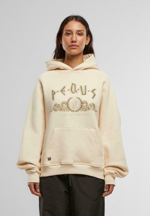 Beige hoodie with a front pocket, oversized sleeves, and text graphics in gold. Features a drawstring hood and ribbed cuffs.