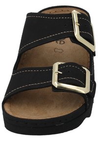 Sandale noire à glissière avec deux courroies croisées, boucles en métal doré et semelle intérieure rembourrée beige. Semelle en caoutchouc texturé visible.