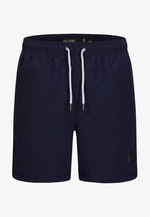 Marineblå svømmebukser lavet af letvægtsstof, med en elastisk talje og en hvid snor samt et lille sort logo-patch.