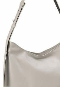 Grijze leren schoudertas met een gladde textuur, een gebogen bovenkant en een verstelbare schouderband. Geen zichtbare hardware of versieringen.