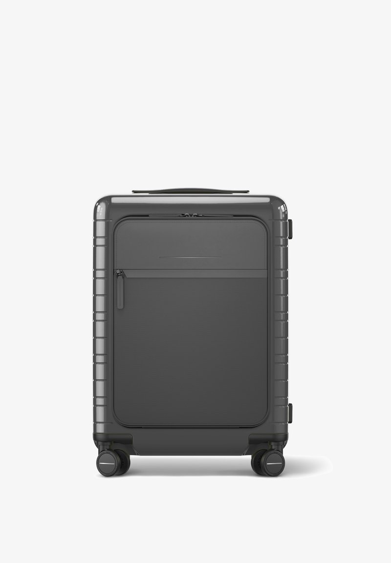 Hartschalenkoffer in Dunkelgrau mit einem schlanken Design, ausgestattet mit einer vorderen Reißverschlusstasche, strukturierten Oberflächen und doppelten Spinner-Rädern.