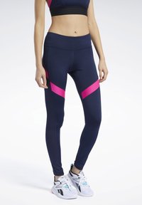 Granatowe legginsy z różowymi ukośnymi akcentami. Wykonane z elastycznego materiału, z wysokim stanem i teksturowanymi bocznymi panelami.