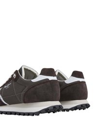 Zapatillas de gamuza marrón con acentos en blanco, suela texturizada y un diseño de perfil bajo. Presenta un logotipo en el costado y un cuello acolchado.