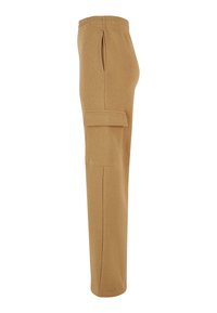Beige Cargo-Hosen mit elastischem Bund. Zu den Merkmalen gehören seitliche Taschen und ein elegantes, gerades Design. Hergestellt aus weichem Baumwollmaterial.
