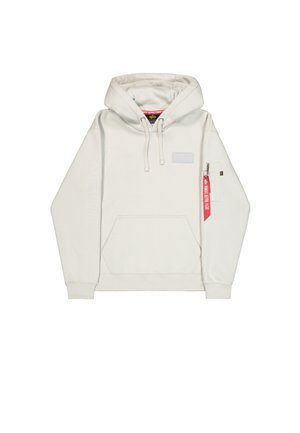 Valge kapuutsiga särk, millel on ees tasku, lipsud ja tõmblukuga küljetasku, kus on punane silt. Sile kangast tekstuur.