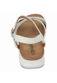 Sandalo bianco con design aperto sul retro, caratterizzato da più cinturini incrociati, una soletta in sughero e una robusta suola piattaforma bianca.