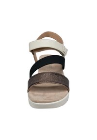 Riemchen-Sandale mit einem Obermaterial aus weißem Leder, einem strukturierten bronzefarbenen Band und einem schwarzen elastischen Riemen. Besitzt ein gepolstertes beiges Fußbett und eine weiße Sohle.