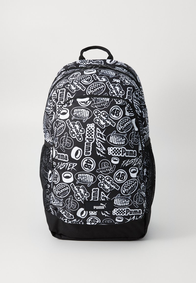 Black and white backpack featuring a mix of logos and text patterns. Made of durable fabric with mesh side pockets and a top handle.