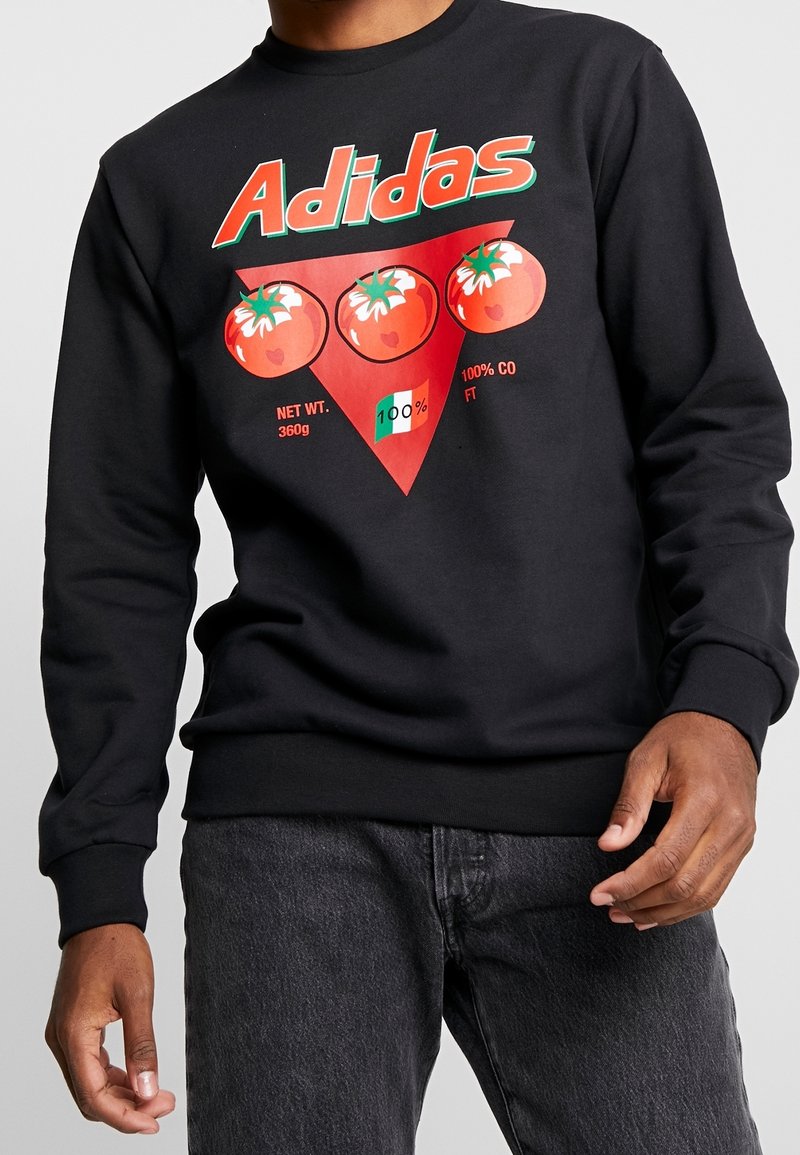 Black sweatshirt with red Adidas text, three tomatoes over a red triangle, and small text including "NET WT. 360g" and "100% CO".