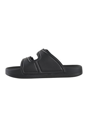 Sandale noire à glissière avec un design découpé, fabriquée en matériau lisse. Elle présente une semelle épaisse et une texture surélevée sur le dessus pour une meilleure adhérence.