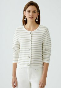 Striped cardigan in cream and beige, knit material, round neckline, long sleeves, five silver buttons down the front, ribbed cuff details.
