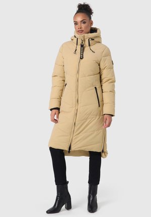 Beige long puffer coat with a hood, diamond quilted texture, black zippered pockets, and adjustable drawstrings at the neck.