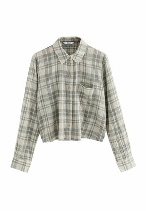 Chemise à carreaux grise et blanche à manches longues avec boutons, col et une poche poitrine, fabriquée en tissu doux et texturé.