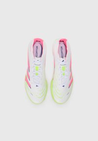 White athletic shoes with pink and green accents. Features sleek design, textured upper, and three stripes logo. Laces and padded collar visible.