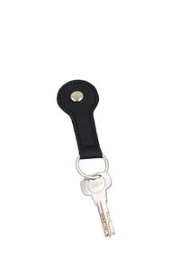 Silver Yale key attached to a round black leather keychain with a metal button snap on a white background.
