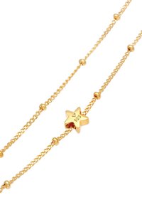 Collana in oro con ciondolo a forma di stella con timbro 925. La catena è delicata con anelli attorcigliati e piccole perline rotonde.