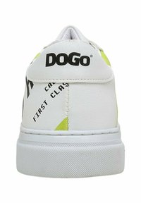 White synthetic leather sneaker with yellow accents, featuring text details and a textured sole. Branding is visible on the heel.