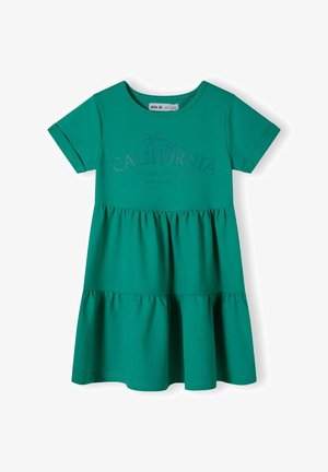 Zöld, rövid ujjú ruha réteges szoknyával, sötétebb zöld Kalifornia mintával. Puha pamutból készült, kerek nyakkivágással.