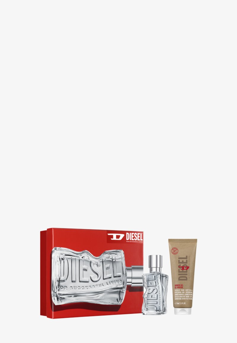 Fragrance gift set featuring a clear, sculpted glass bottle with embossed "DIESEL," a silver cap, and a tan tube of body wash in a red box.