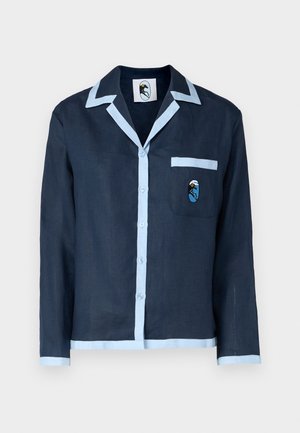 Námornícka ľanová košeľa s svetlomodrým golierom a lemovaním vrecka. Obsahuje vrecko na prsiach s vyšitým vzorom. Zapínanie na gombíky po celej dĺžke vpredu.