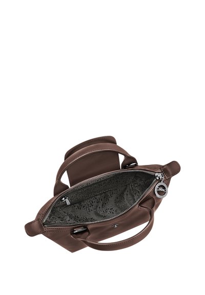 Brown leather handbag with open top zipper showing grey patterned interior lining and two short handles.