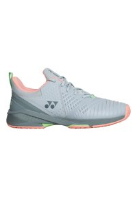 Light gray athletic shoe with a textured upper, pink accents on the collar and sole, green heel tab, and a patterned midsole for support.