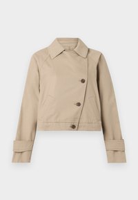 Veste cropped beige en mélange de coton, avec un col pointu, une fermeture à double boutonnage et deux poches avant.
