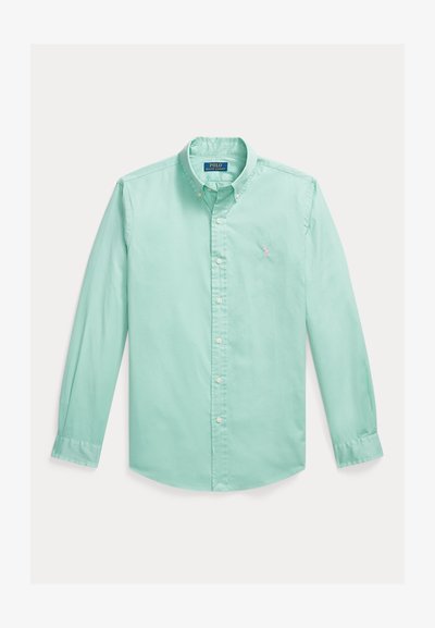 Πουκάμισο μέντας με μακριά μανίκια, κουμπώνει με κουμπιά και έχει γιακά που κλείνει με κουμπί, με μικρό κεντημένο λογότυπο στο αριστερό μέρος του στήθους.