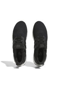Pair of black knit running shoes with white soles, black laces, and "END PLASTIC WASTE" text inside the heel area.
