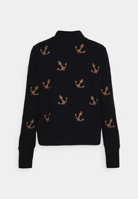 Cardigan navy con ancore marroni ricamate su tutta la superficie. Presenta un colletto e polsini a coste, e un orlo inferiore fitted. Materiale in misto cotone.