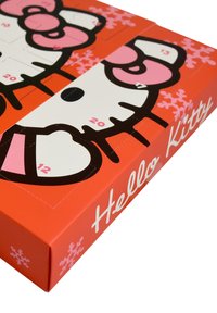 Hello Kitty-themed advent calendar in bright orange, featuring a cartoon cat face, pink accents, and numbered doors for each day.