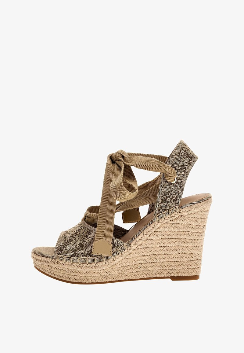 Sandale compensée beige avec plateforme en jute tressé, brides en tissu à motifs et une large bride à nouer à la cheville.