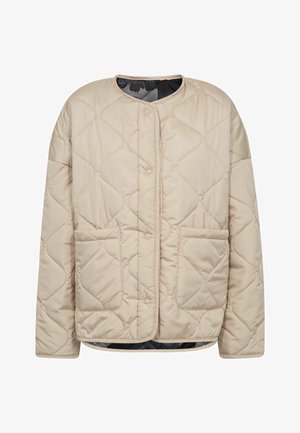 Beige quilted jacket with a round neckline, front button closure, two patch pockets, and a black camo inner lining. Soft material.