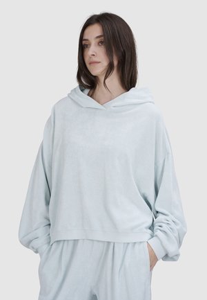 Lichtblauwe, oversized hoodie van zachte stof met een capuchon en geribde zoom. Bevat losse mouwen en een relaxte pasvorm.