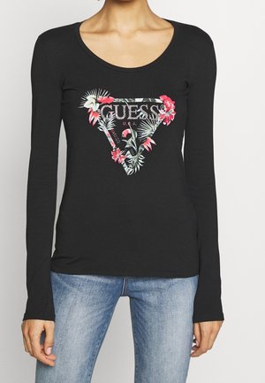 Zwarte langetermijnshirt met een bloemenaccent driehoek logo met "GUESS U.S.A." in zilver, gemaakt van zachte stof, met een aansluitend ontwerp.