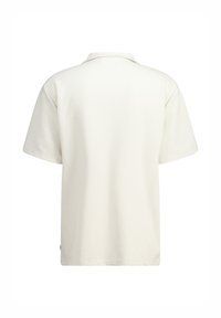 Polo paita lyhyillä hihoilla vaaleassa beessissä, jossa on teksturoitu kangas, klassinen kaulus ja suora leikkaus rennosti istuvana.