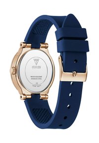 Sinine silikoonist rihm kell kuldse roostevabast terasest korpusega. Omab ümmargust nägu ja veekindlat tagapinda. Reguleeritav rihm klamberkinnitusel.