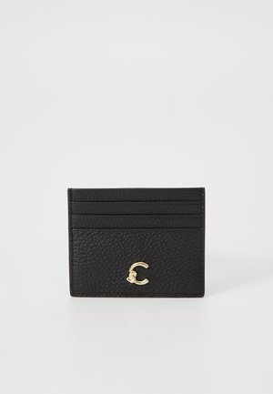 Black leather cardholder with textured finish, featuring five slots and a gold logo accent on the front. Compact and rectangular design.
