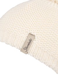 Cream-colored knitted beanie with a ribbed edge and a sewn beige fabric tag reading "Sterntaler."