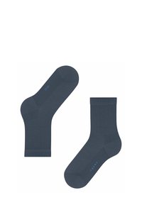 Chaussettes bleu marine avec un motif en chevrons. Présentent une texture lisse et des poignets côtelés. Nom de la marque "Falke" affiché en bleu sur la semelle.