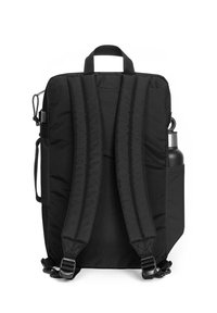 Black backpack with padded shoulder straps, flat design, top handle, side pocket for water bottle, and adjustable buckles. Smooth texture.