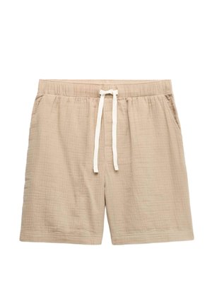 Shorts beiges décontractés avec taille élastique et cordon blanc, fabriqués en tissu léger texturé, dotés de poches latérales.