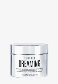 Silverfärgad cylindrisk burk med en reflekterande yta. Svart text visar "COLOR WOW DREAMING" och produktinformation. Kapacitet: 215 ml.
