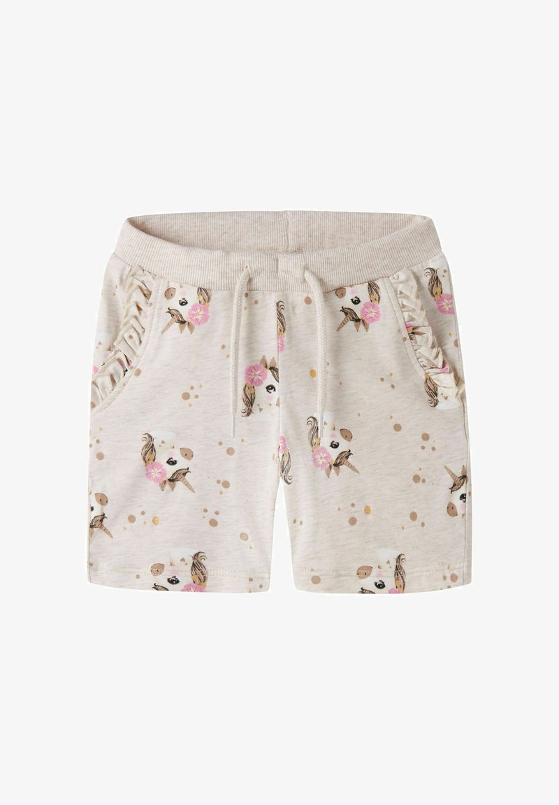 Short beige pour tout-petit avec taille élastique, cordon, poches latérales à volants et motifs de visages de licornes avec des fleurs roses et des points dorés.