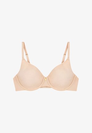 Reggiseno beige con ferretto, coppe sagomate, spalline regolabili e un piccolo dettaglio a charm dorato al centro davanti.