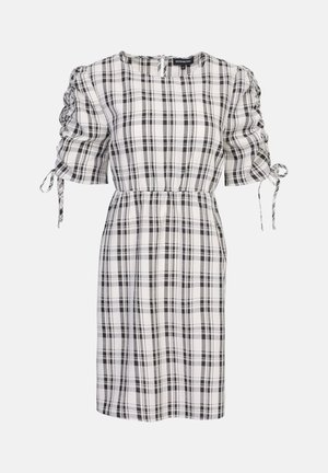 Mustvalge ruuduline kleit puffvarrukatega, elastsete kogumise detailidega, ümar kaelus ning lipsuaktsent mansettides.