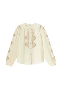 Blouse crème avec de longues manches bouffantes, ornée de motifs brodés marron le long des épaules et des manches, fermeture à boutons sur le devant.