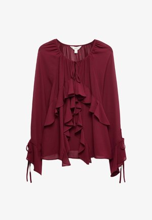 Blouse bordeaux avec des volants sur le devant, fermeture à nouer au cou, et manches longues avec tissu froncé et attaches aux poignets. Texture lisse.