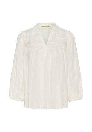 Lengvas baltas bluzonas su minkšta tekstūra, vertikaliomis juostelėmis, smailiu apykaklės dizainu ir raukšlėtomis baliono rankovėmis. Yra V formos iškirptė.